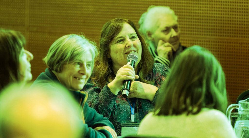 Cindy speaking at a Conference
