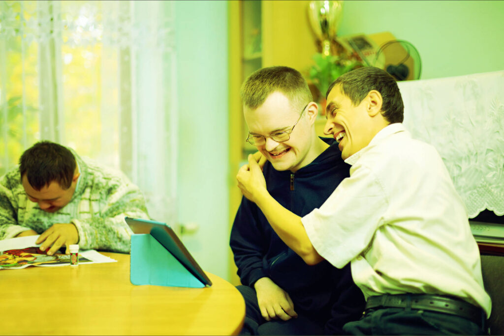 disabled person and carer having a hug