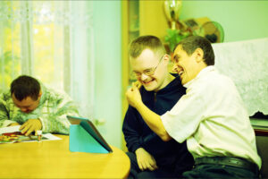 disabled person and carer having a hug