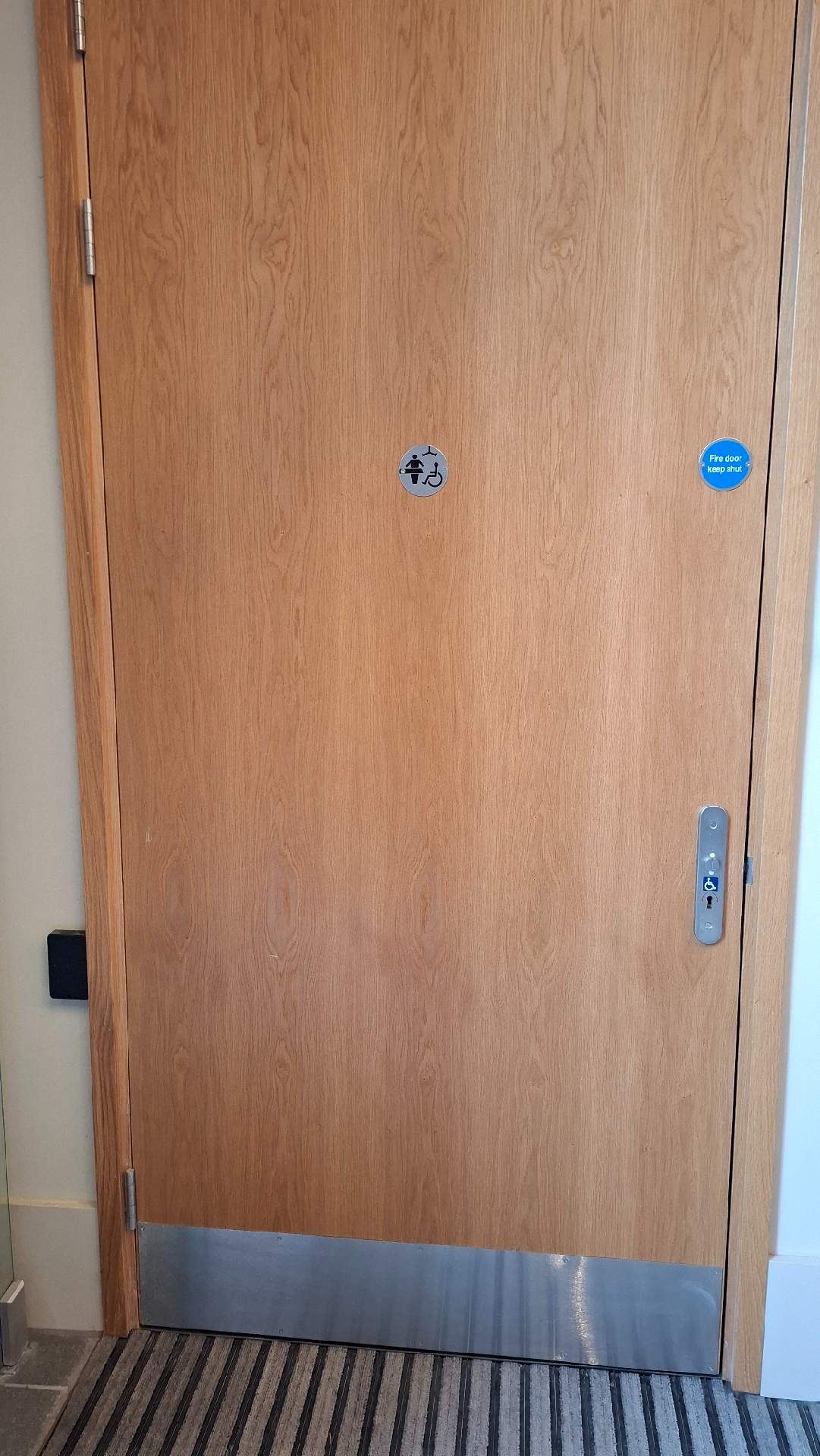 Tiny signage on door for a Changing Place