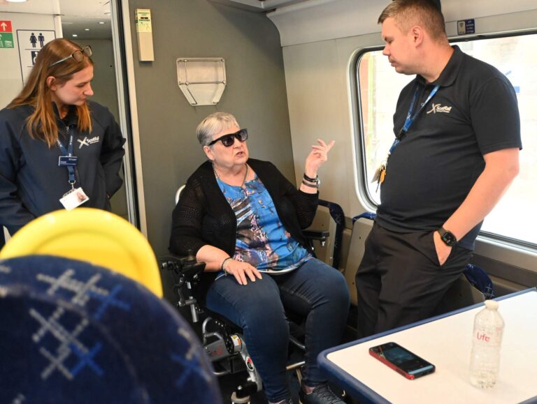 Member asking a question to Scotrail staff on accessibility on Trains